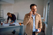 © Drazen - Happy man talking on cell phone at his renovating home. Copy space.
