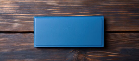 Poster - Business card holder in blue on a wooden backdrop with copy space image.