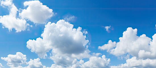 Wall Mural - sunny day with a blue sky filled with fluffy white clouds, ideal for the perfect copy space image.