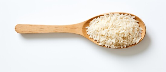 Aufkleber - Top view of a wooden spoon filled with uncooked raw white long-grain rice on a white background, featuring copy space image.