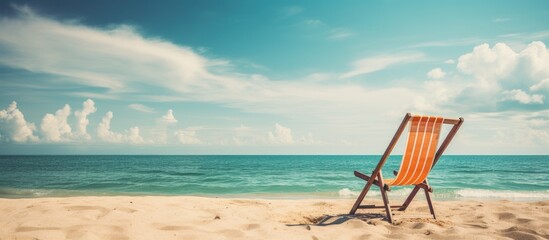 Poster - An empty, colorful wooden deckchair on a tropical beach, set against a sunny sky, in vintage retro style, as a symbol of summer vacation, suitable as a copy space image.