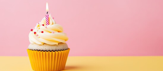 Aufkleber - A single festive cupcake in a paper cup with a yellow candle for a birthday surprise, set against a pink background for a greeting card with ample copy space image.