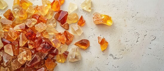 Aufkleber - Amber. Heap of natural unprocessed pieces of amber of different colors, shapes and sizes on a pastel background. Fossil resin as a material for jewelry. Lot of pieces of sunstone from above. Texture