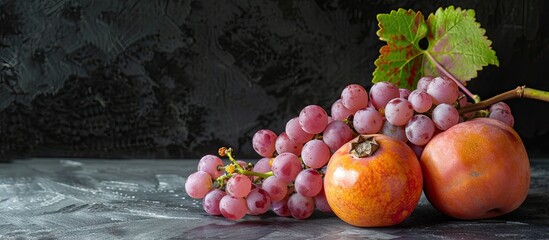 Poster - Ripe pink grapes and a persimmon isolated on black background with copy space image.
