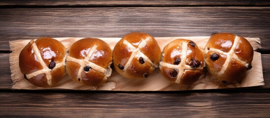 Poster - Easter hot cross buns displayed from above on a wooden background with ample copy space for customization in the image.