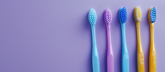 Poster - A flat lay image showcasing natural dental care with blue and purple toothbrushes along with blue and yellow interdental brushes against a copy space backdrop.