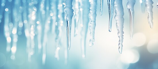 Fototapete - Nature background in light blue, featuring transparent icicles on snow, creating a refreshing, serene setting for copy space image with soft focus.