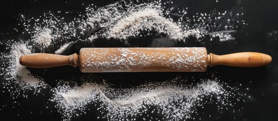 Poster - Top view of a rolling pin dusted with flour on a black backdrop, perfect for adding text or visuals, creating a baking-themed copy space image.