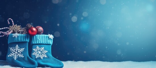 Aufkleber - Knitted socks with Christmas gift box on a blue background, with copy space image.