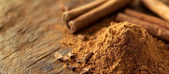 Leinwandbilder - Close-up of fragrant ground cinnamon powder on a textured wooden background, perfect for baking, desserts, and drinks, with available space for text or images. with copy space image