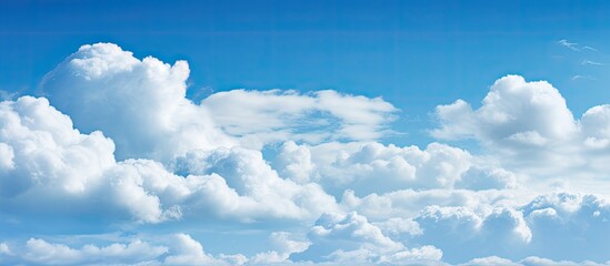 Poster - Clouds in a clear blue sky with copy space image.