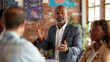 © paco - Leader Engaging with Team in Casual Setting. This image showcases a dynamic leader speaking to his team in a casual, yet professional setting.