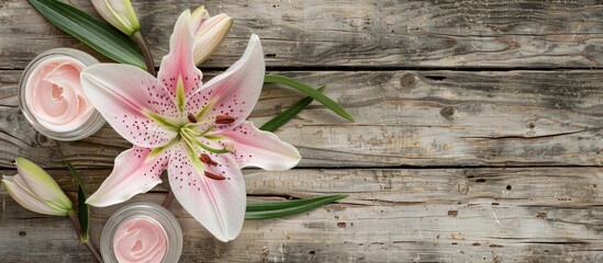 Poster - Weathered wooden table background with a pink lily flower and cosmetic cream, creating a charming copy space image.