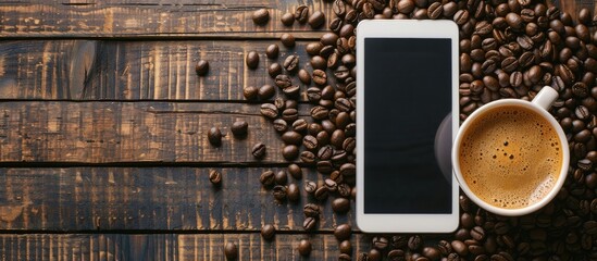 Canvas Print - Coffee cup next to coffee beans and a tablet on a wooden table, with copy space image.