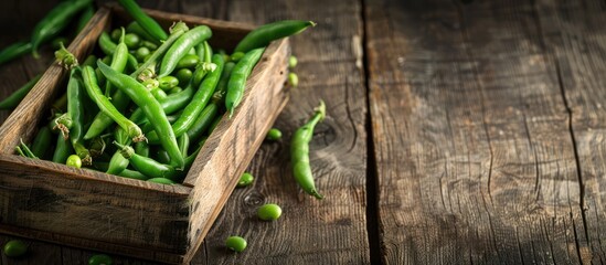 Aufkleber - Fresh organic green common beans or kidney beans in a wooden box for cooking, set against a wooden boards background with room for text or images. Copy space image. Place for adding text and design
