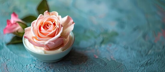 Poster - Isolated cream cosmetic with a beautiful rose flower in the copy space image.
