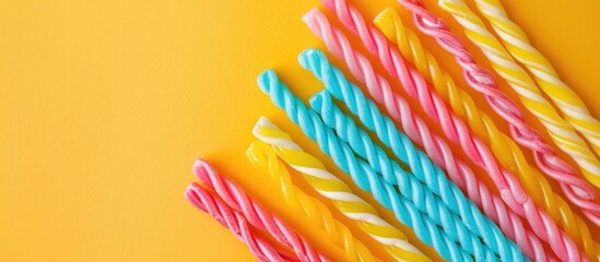 Sticker - Colorful candy sticks displayed on a bright backdrop with ample copy space image.