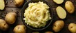 © StockKing - A detailed close-up photo showcasing a bowl of mashed potatoes surrounded by whole potatoes. image with copy space