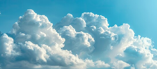 Poster - close-up of a blue sky with fluffy white clouds against a blank background, providing ample copy spa