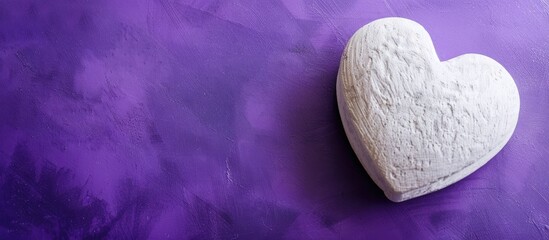 Poster - A single white heart on the right against a purple backdrop with copy space image, representing love and passion for Valentine's Day.