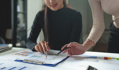 Wall Mural - Team work process Team of business people searching for piles of papers and having a meeting Discuss business statistics, profits, financial growth rates in graph papers. financial data chart.