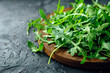 © harysxu - Arugula or rucola leaves on wooden plate, healthy green salad. Generative AI