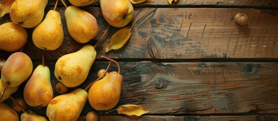 Poster - Autumnal scene with yellow pears arranged on a rustic wooden table, featuring copy space image.