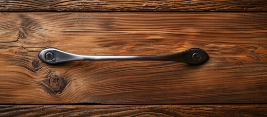 Poster - Close-up image of furniture handle on a wooden texture background with space for copying.