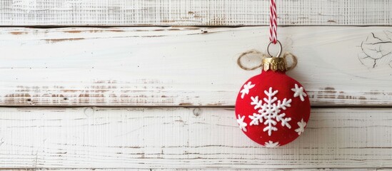 Poster - Fabric Christmas ornament hanging on white wooden backdrop with copy space image.