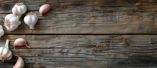 Poster - Close-up of fresh garlic cloves on a wooden backdrop with copy space image.