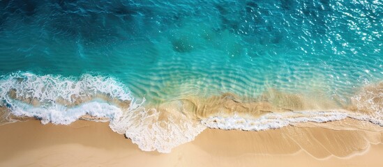 Poster - Aerial view of a sandy beach with transparent blue and turquoise waters, suitable as a horizontal background with copy space image.