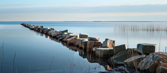 Poster - A breakwater on Beloye lake provides a sense of protection and safety with a serene background for a copy space image.
