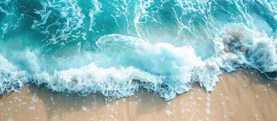 Poster - Turquoise ocean waves gently caressing a sandy beach, captured in a high-angle copy space image.