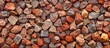 © Gular - Textured red gravel background on a wall with copy space image.