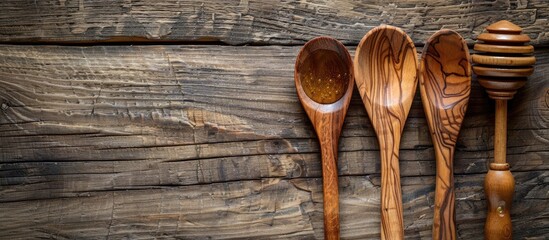 Aufkleber - Handcrafted wooden utensils, including a spoon, fork, and honey dipper, arranged on a rustic wooden table with copy space image.