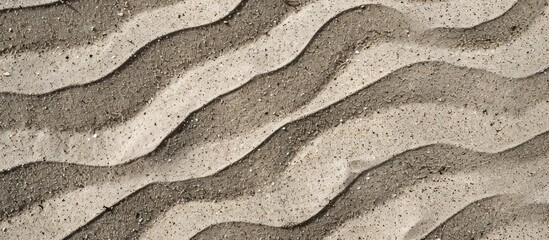 Poster - Close-up view of natural beach sand texture with wavy ground, creating a background, seen from the top with copy space image.