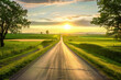 © Tjeerd - Country gravel road and green wheat field with sky clouds at sunset