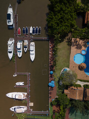 Wall Mural - River boating marina and resort waterfront from top down aerial view