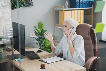 Sticker - Photo of happy charming senior lady secretary wear formal shirt communicating modern gadget indoors workshop workstation