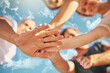 © Stratford/peopleimages.com - Hands, huddle and sky with friends outdoor in summer together from below for solidarity or unity. Community, support and team building with group of people in nature on clouds for motivation