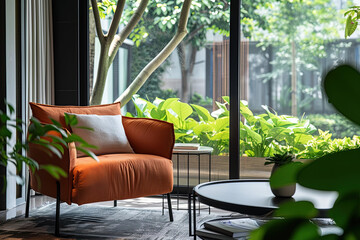 Wall Mural - A modern living room with an orange velvet armchair, surrounded by lush green plants and trees outside the large windows. A black metal coffee table sits in front of it.