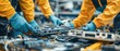 © Purichaya - Workers dismantling old electronics for battery recovery, recycling process, waste reduction