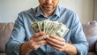 © Musarrof - Caucasian man counting us dollar banknotes. Saving financial concept, money for payment