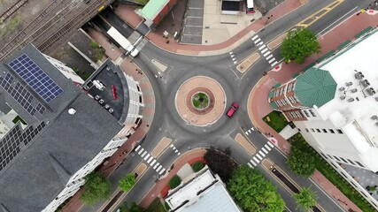 Wall Mural - roundabout with vehicles driving, surrounded by urban buildings and trees in Bound Brook New Jersey