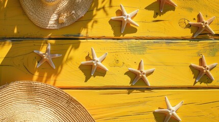 Wall Mural - Starfish varying in size placed on yellow wooden surface with shadow of straw hat