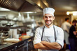 © Klemenso - Happy chef in a bright kitchen, poised to create exquisite dishes.