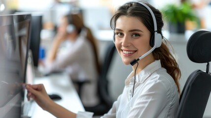 Wall Mural - A friendly and smiling customer service representative sits at her desk, wearing a headset and focusing on her computer screen