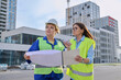 © Valerii Honcharuk - Two confident women talking working on construction of residential office building