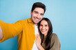 © deagreez - Portrait of two young people make selfie hug wear shirt isolated on blue color background
