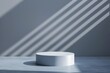© wanavit - Minimalist white pedestal with dramatic light and shadow effects, ideal for product display or presentation in a modern setting.
